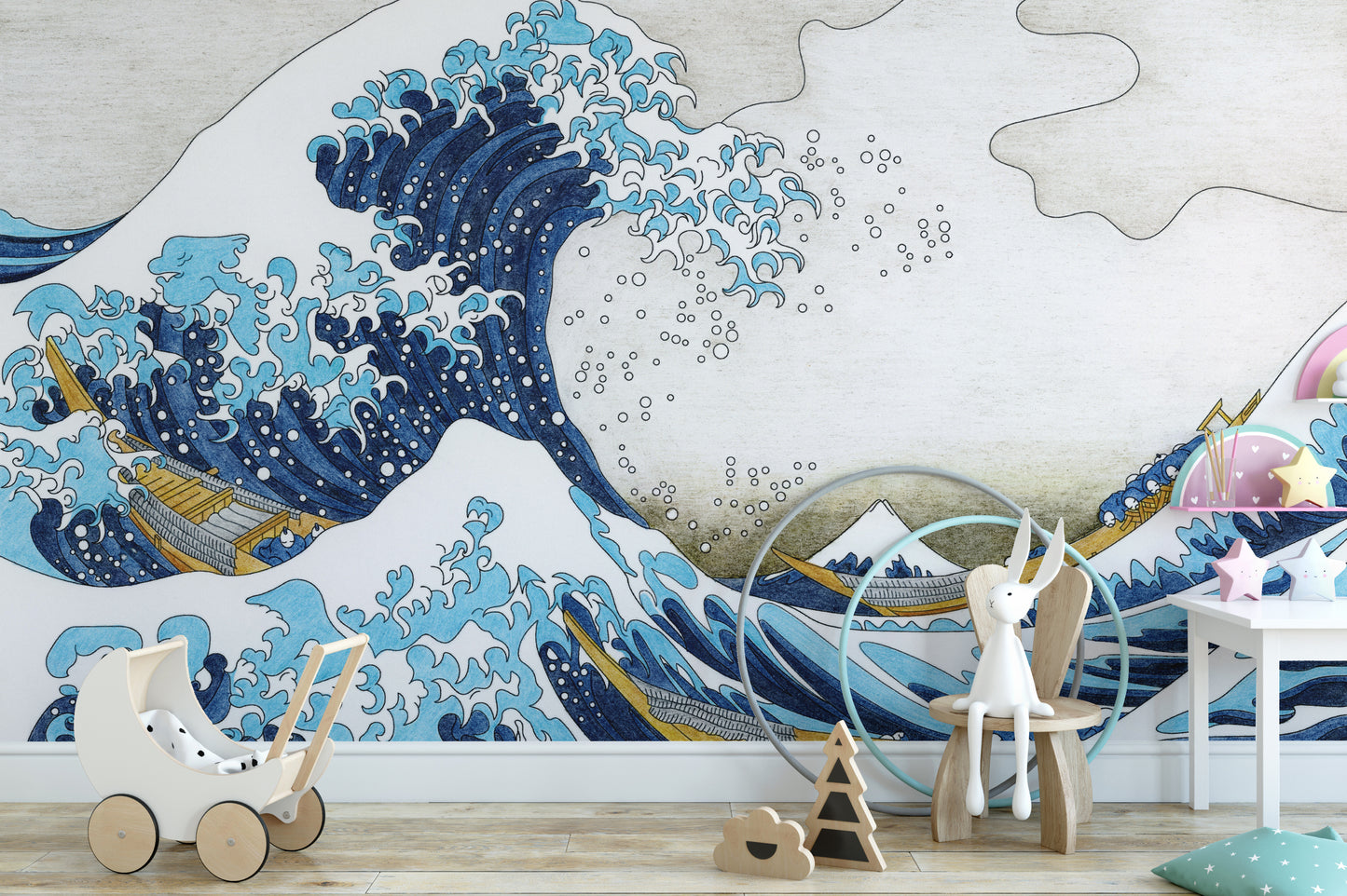 The Great Wave Kanagawa blue ocean wallpaper mural beside a white toy pram and wooden chair in a nursery