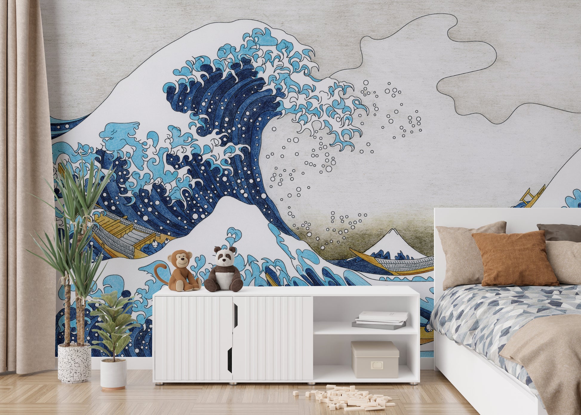 The Great Wave Kanagawa wallpaper mural with Mt Fuji behind a white sideboard and bed with blue bedding in a kids room