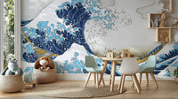 The Great Wave Kanagawa blue wave wallpaper mural above a white kids play table with pastel chairs and plush toys