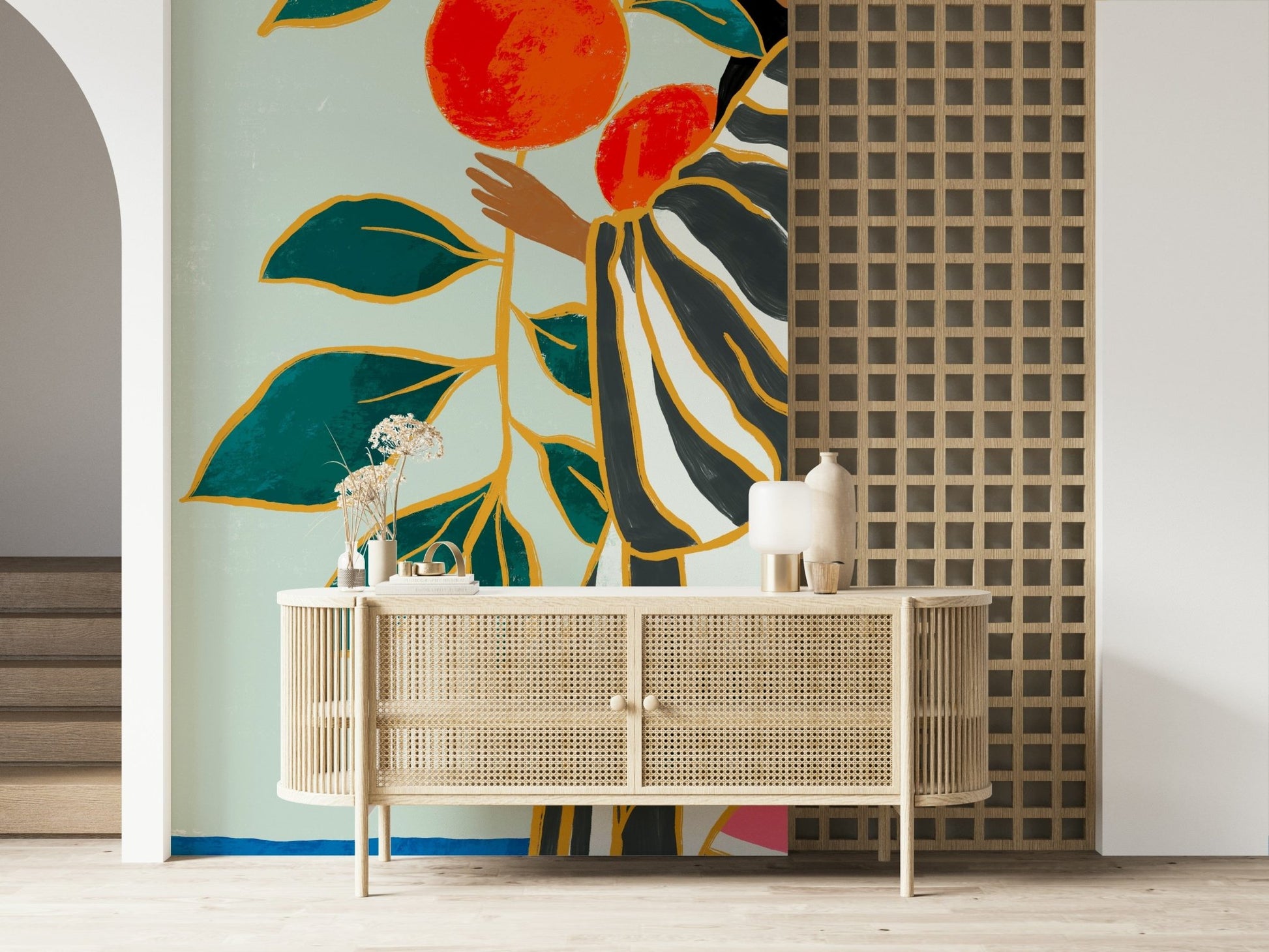 The Keeper of Oranges wallpaper mural with oranges and teal leaves above a cane sideboard in an entryway