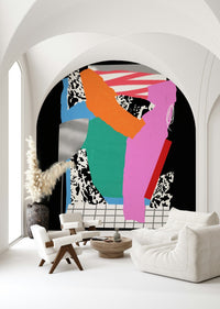 Contemporary wall mural with earthy hues in a bright studio apartment.