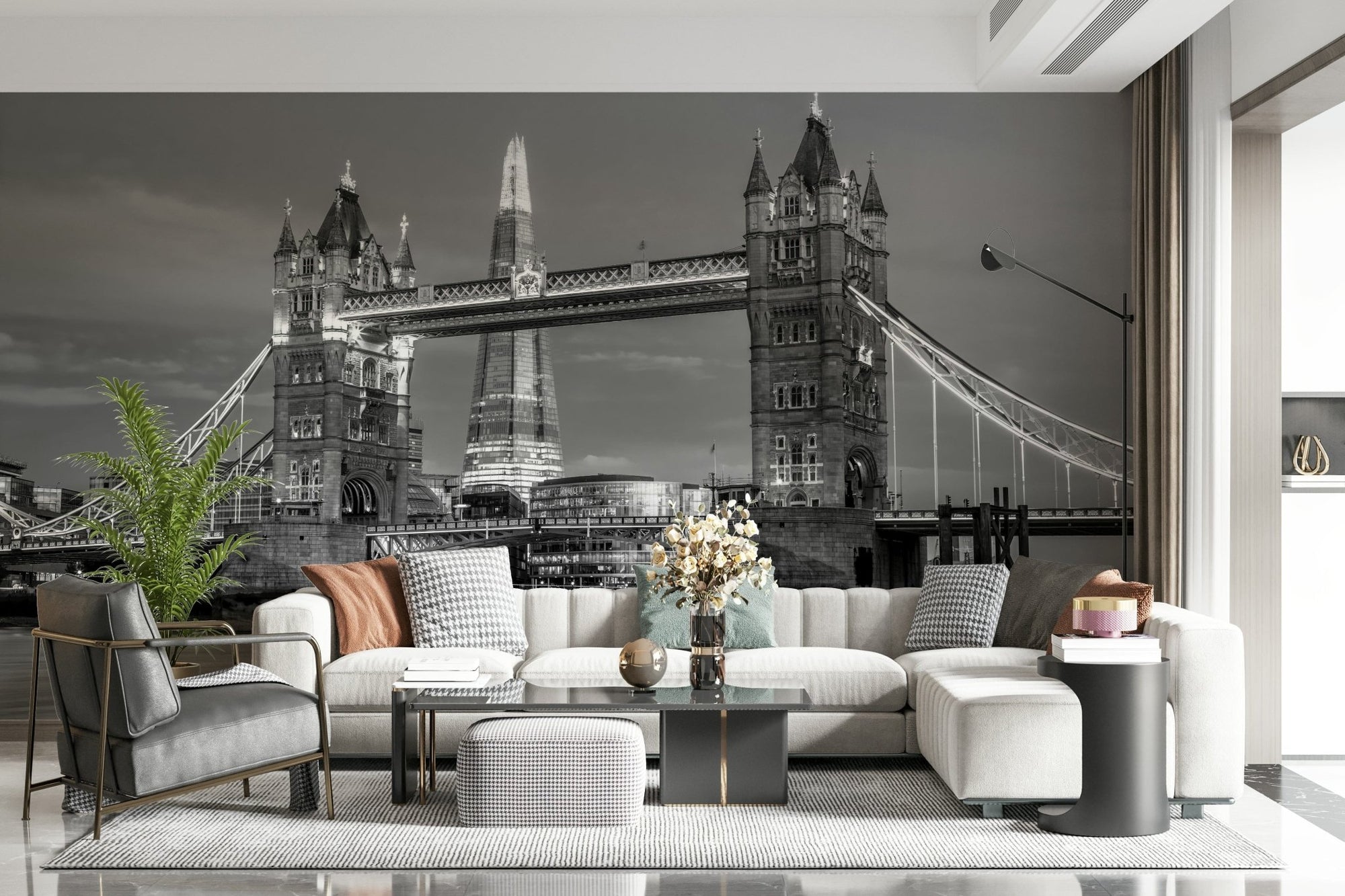 Tower Bridge and the Shard wallpaper mural over a cream sectional and black leather chair in a living room