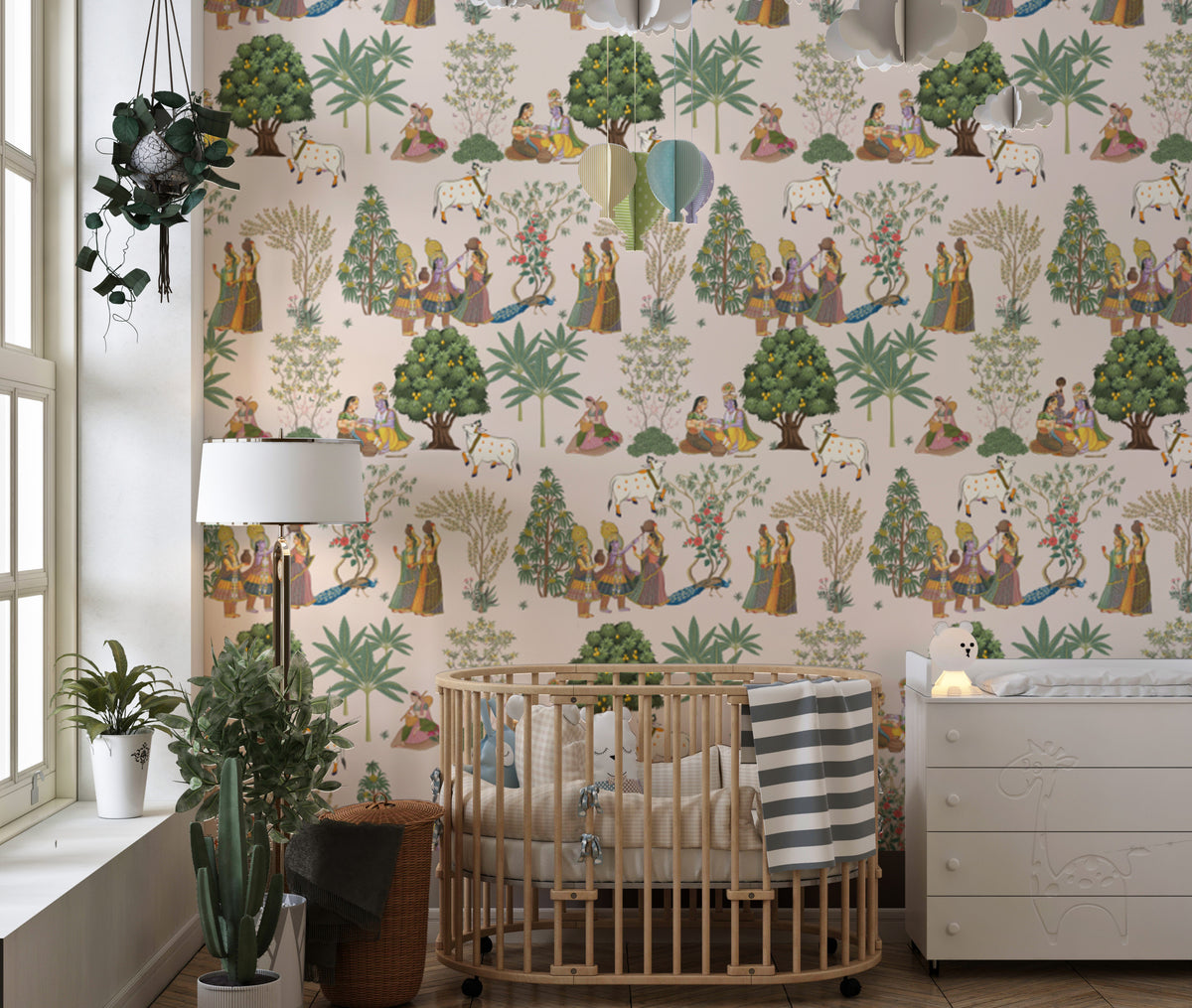 Traditional Indian Cultural wallpaper in cream with cows, folk figures and green trees in a nursery with a wooden crib