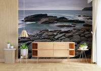 Rocky coastal tide scene on bedroom feature wall