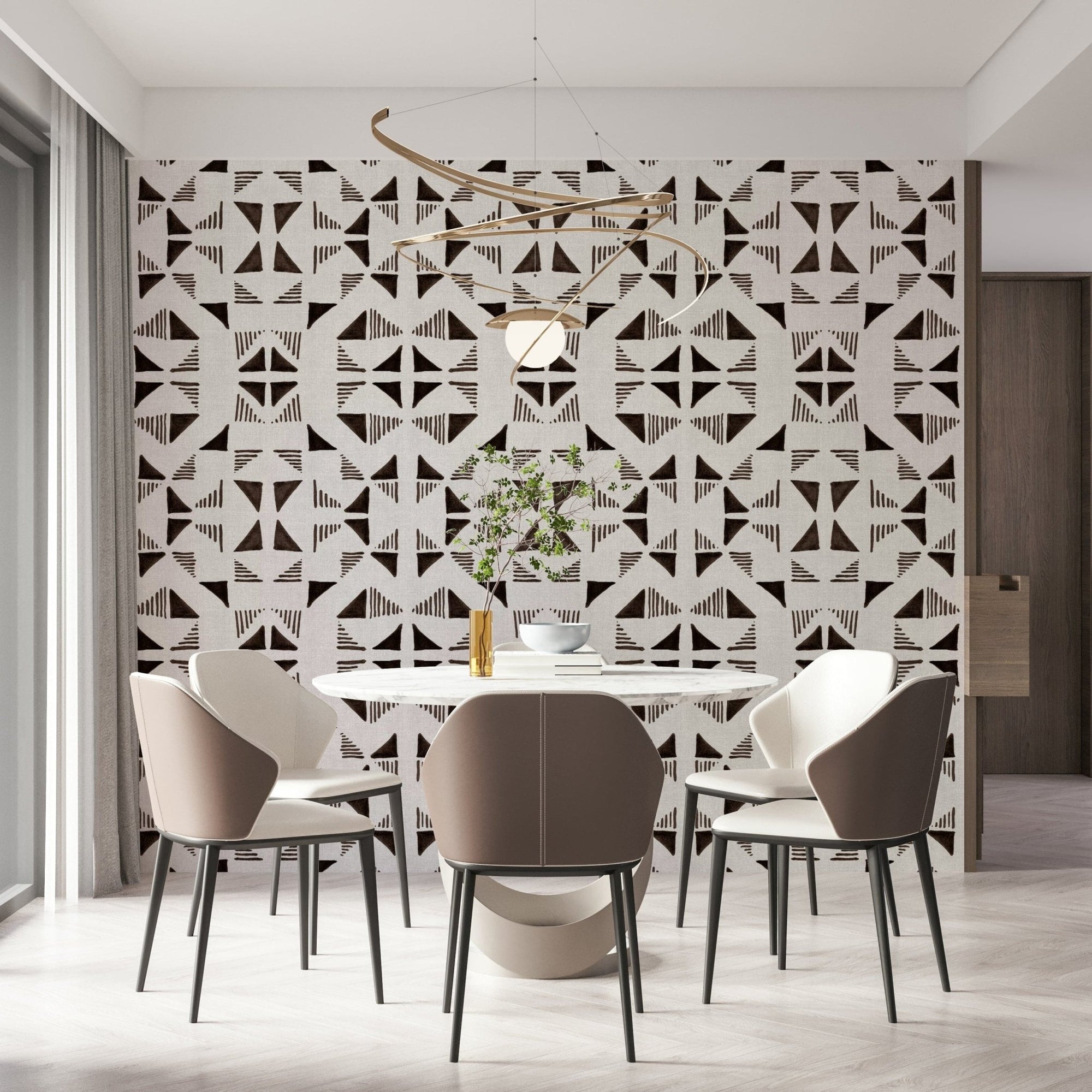 Triangles Composition Chocolat wallpaper in brown and cream behind a round dining table with taupe chairs