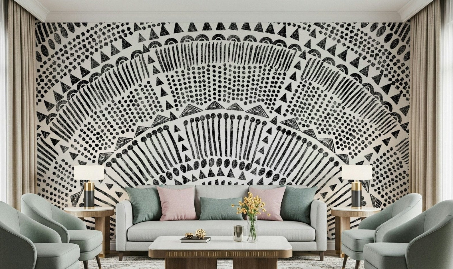 Tribal Half Sun wallpaper mural in black and white behind a white sofa and sage armchairs in a living room