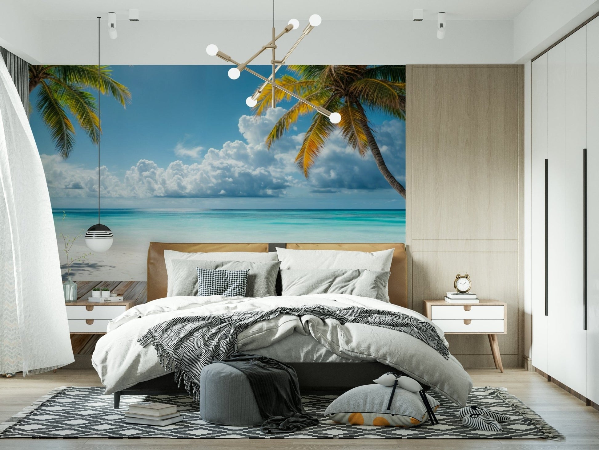 Tropical Beach View wallpaper mural of ocean and palms above a bed with grey bedding and a sputnik chandelier in a bedroom