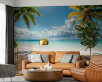 Tropical Beach View wallpaper mural behind a caramel leather sofa and gold arc lamp in a living room with a fiddle-leaf plant