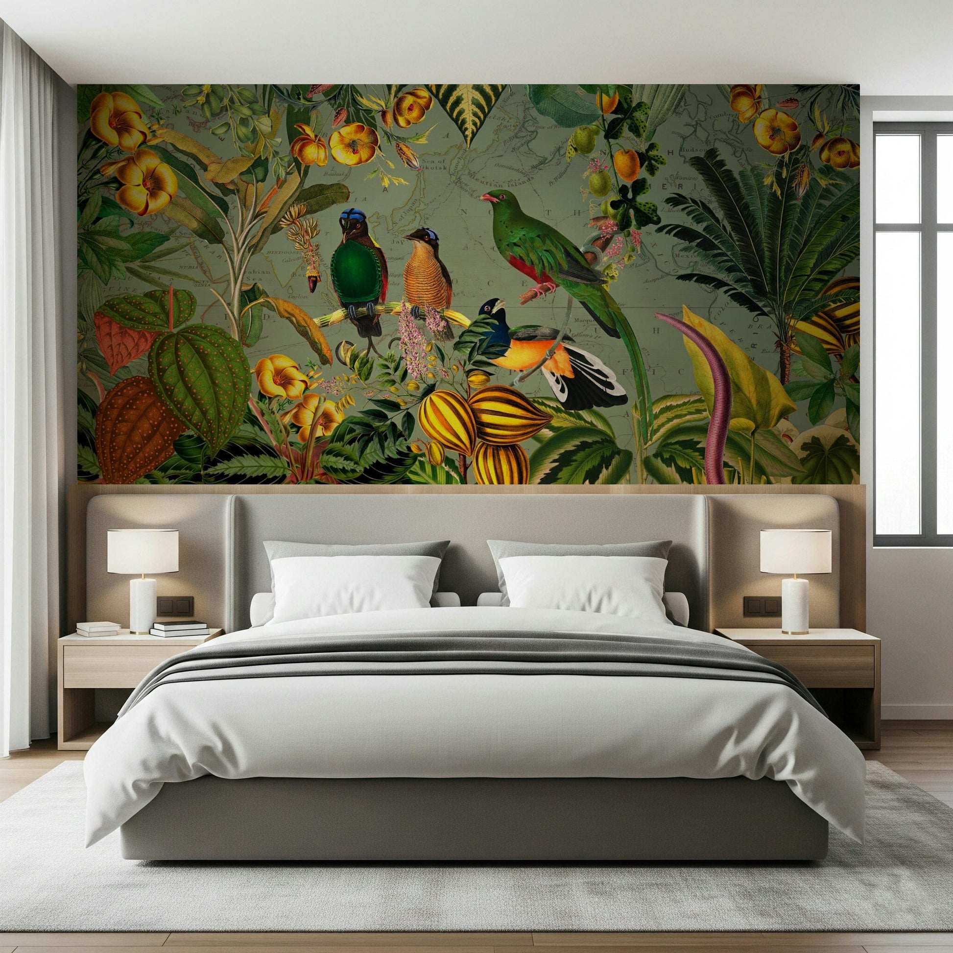 Tropical Explorers' Chart mural above a grey upholstered bed with white bedding and twin lamps