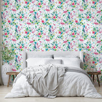 Lively jungle scene wallpaper with green foliage and pink birds.

