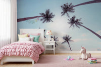 Wide angle Tropical Palms Sky View Wall Mural with light blue tones.
