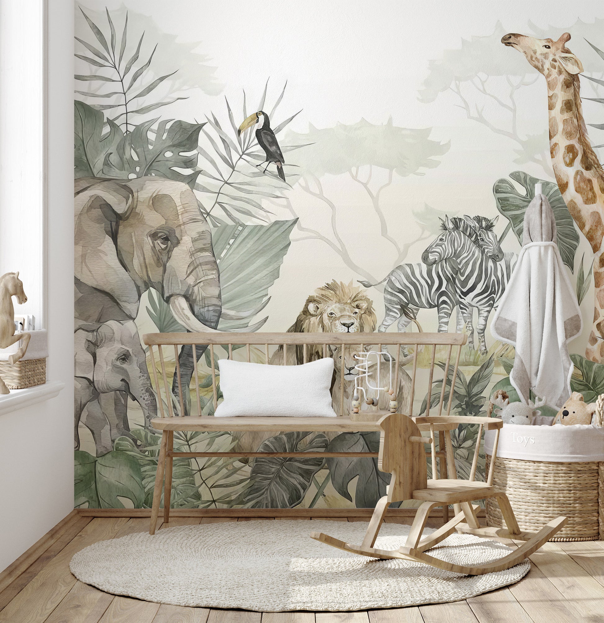 Tropical Wildlife wallpaper mural with elephant and giraffe behind a wood bench and rocking toy in a nursery