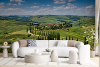 Living room with serene countryside wall mural and tall cypress rows