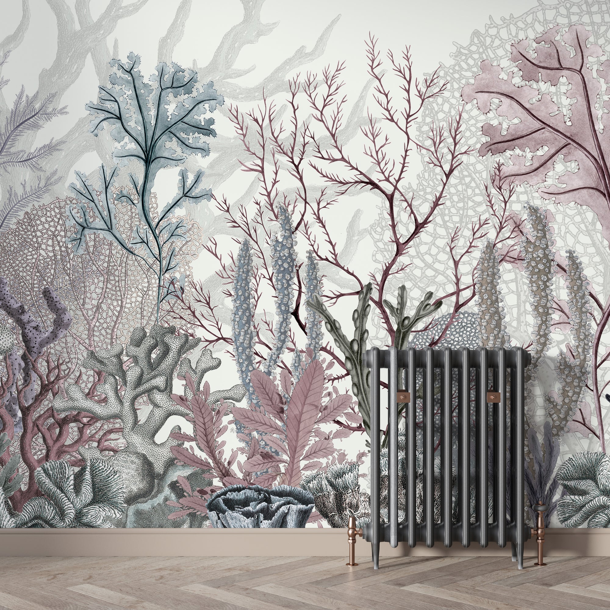 Underwater Coral Reef wallpaper mural in pastel tones behind a grey cast-iron radiator on herringbone floor