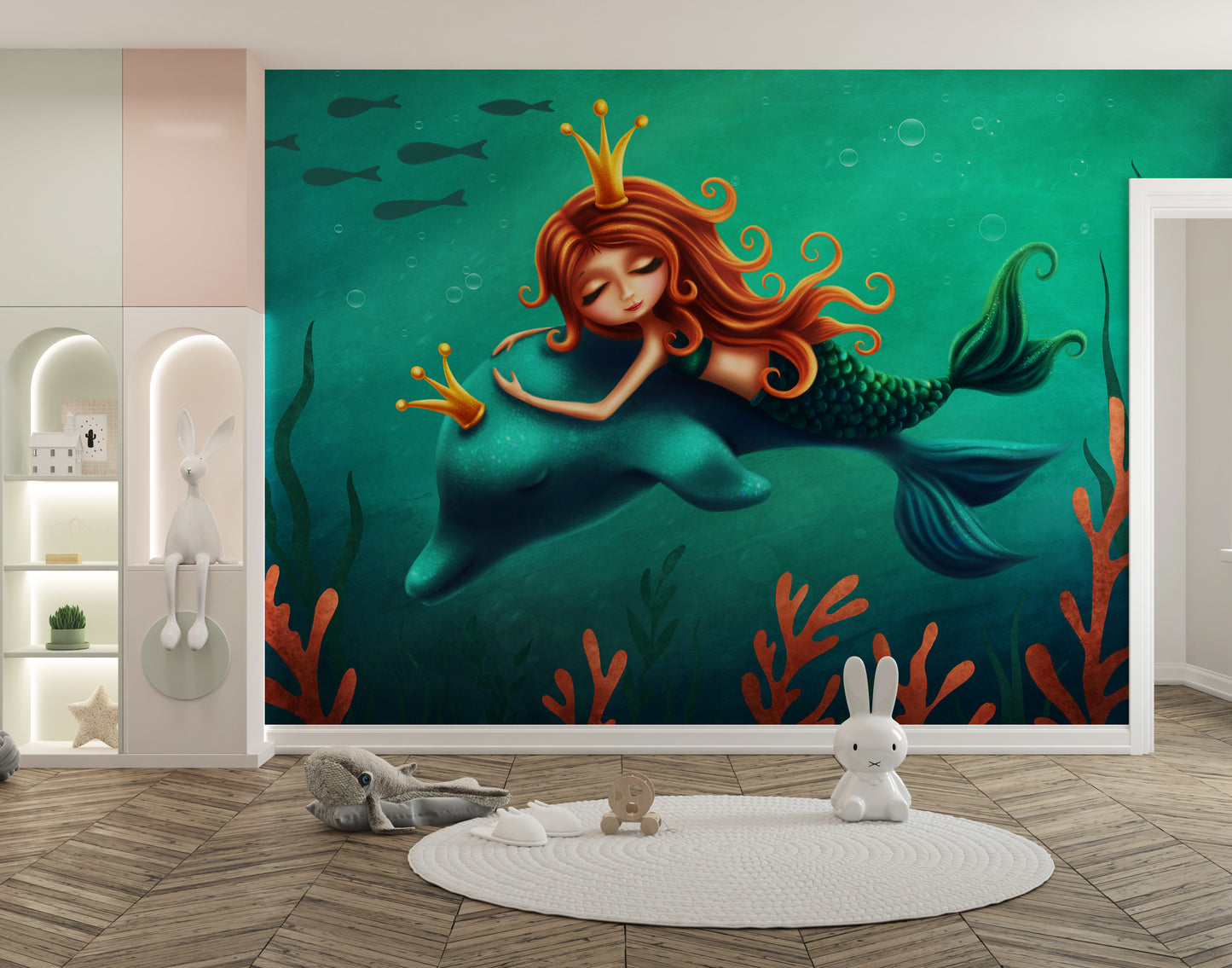 Underwater Mermaid and Dolphin Ride wallpaper mural in teal beside a lit bunny shelf and round rug in a kids playroom
