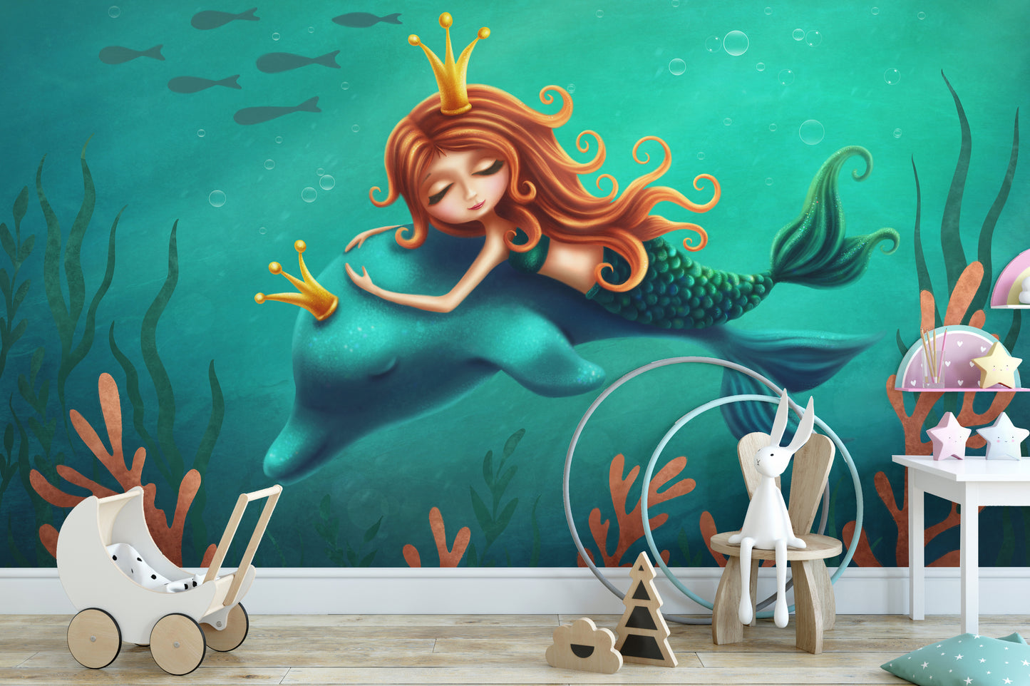 Underwater Mermaid and Dolphin Ride wallpaper mural in teal behind a toy pram and bunny chair in a kids room