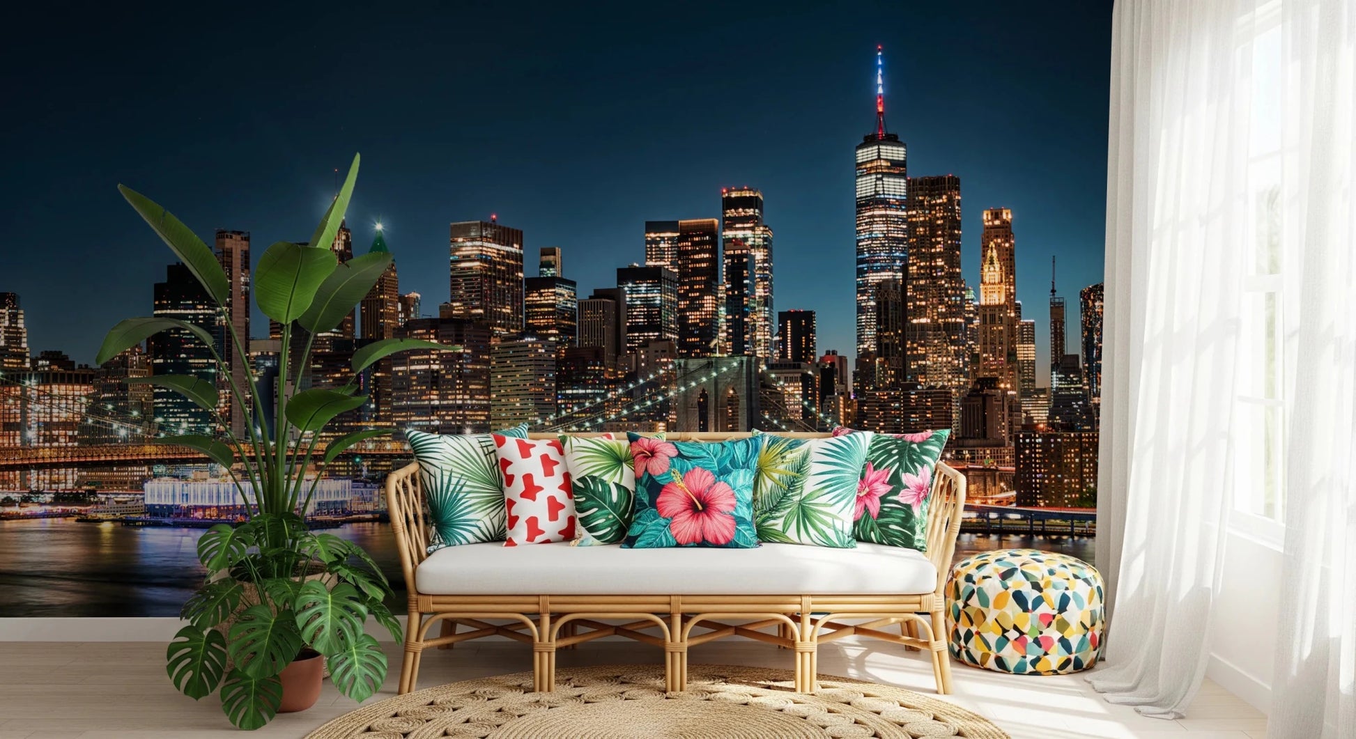 Urban Nightscape wallpaper mural behind a rattan sofa with tropical hibiscus cushions and leafy plants