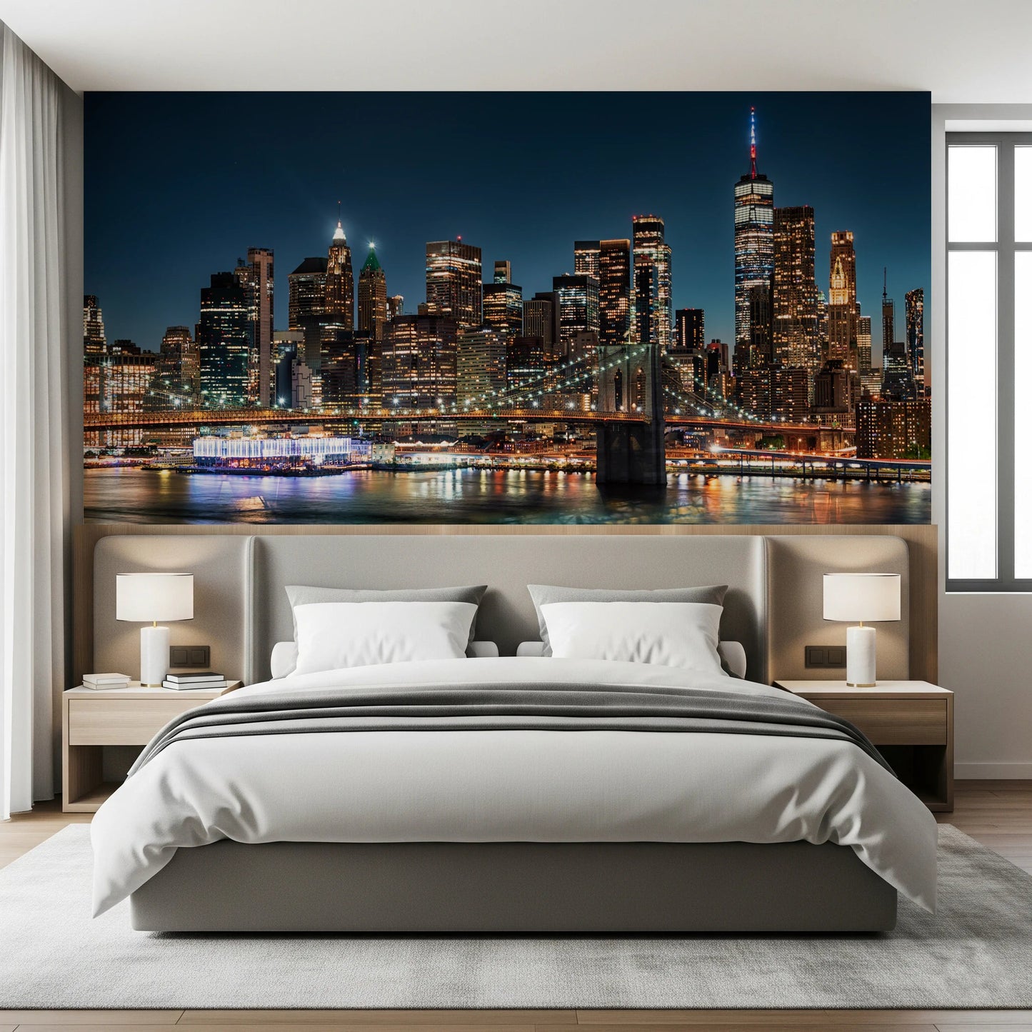 Urban Nightscape wallpaper mural of New York above a grey upholstered bed flanked by white bedside lamps