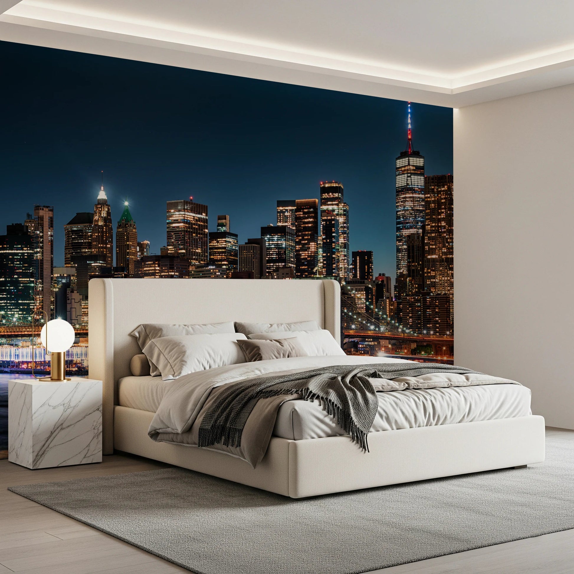 Urban Nightscape wallpaper mural of New York at night behind a cream upholstered bed in a modern bedroom