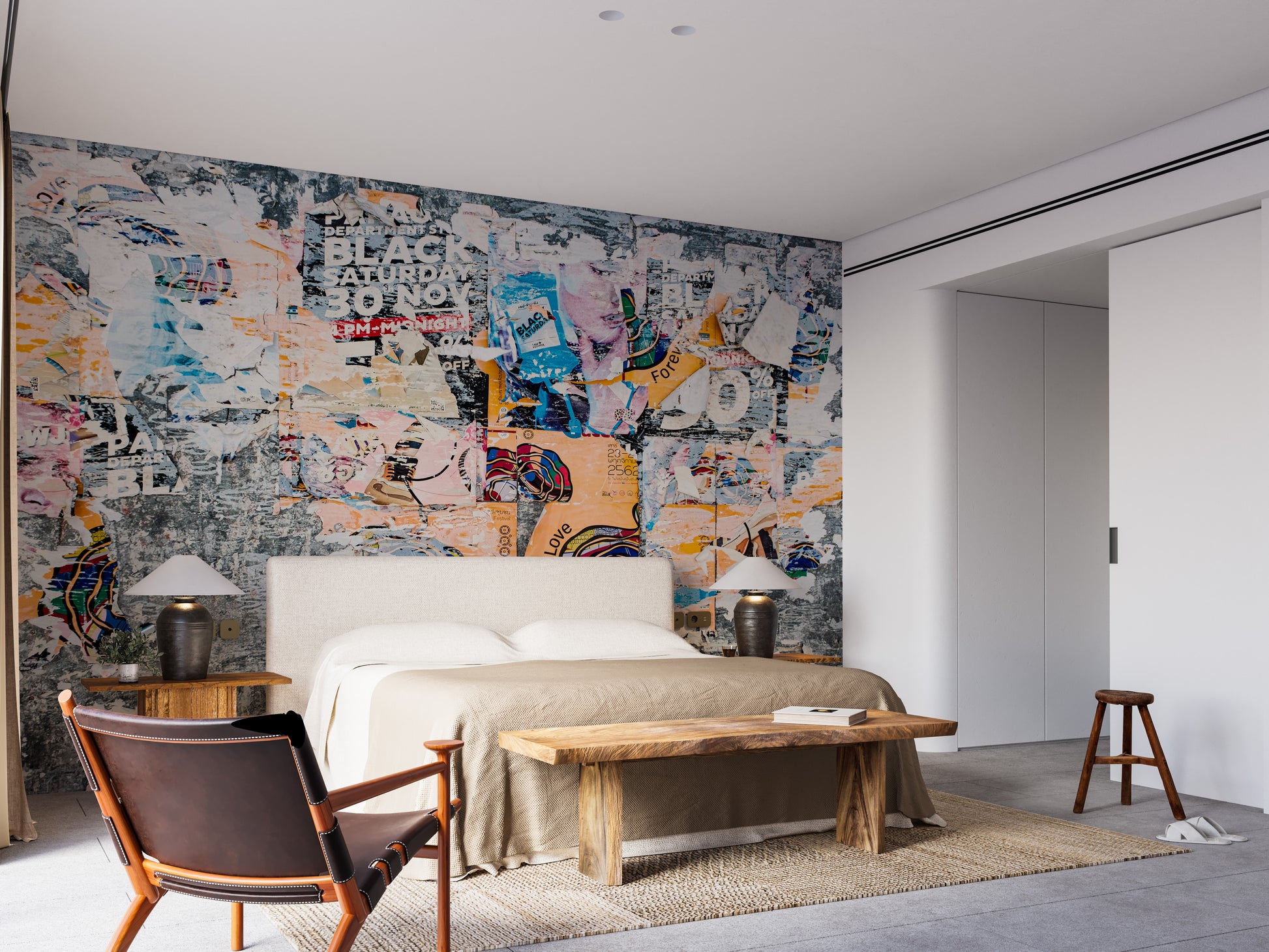 Urban Poster Patchwork wallpaper mural in a bedroom with a cream bed, black lamps and a leather armchair
