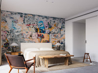 Urban Poster Patchwork wallpaper mural in a bedroom with a cream bed, black lamps and a leather armchair