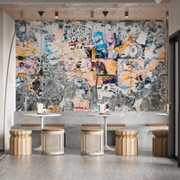 Urban Poster Patchwork wallpaper mural of weathered posters above white cafe tables with rattan stools