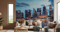 Urban Serenity wallpaper mural of a waterfront skyline behind a white sofa with boho pillows and a rattan coffee table