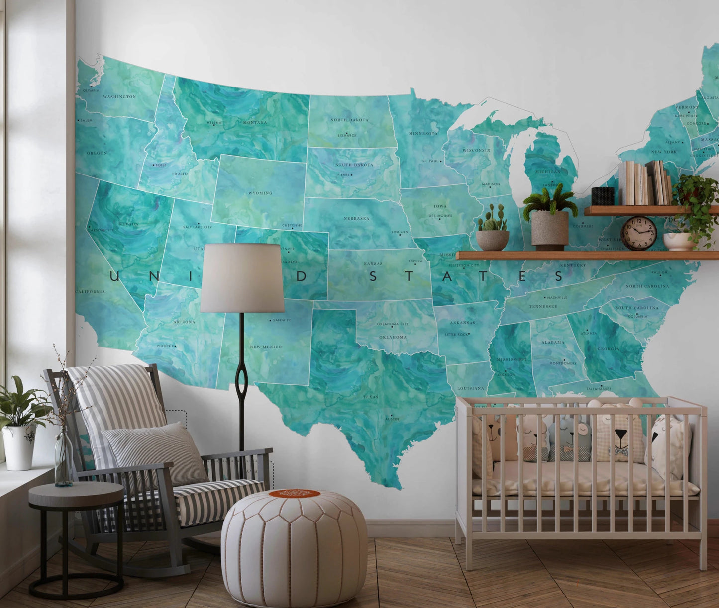 USA map with states and capitals in teal watercolor wallpaper mural in a nursery with a white crib and rocking chair