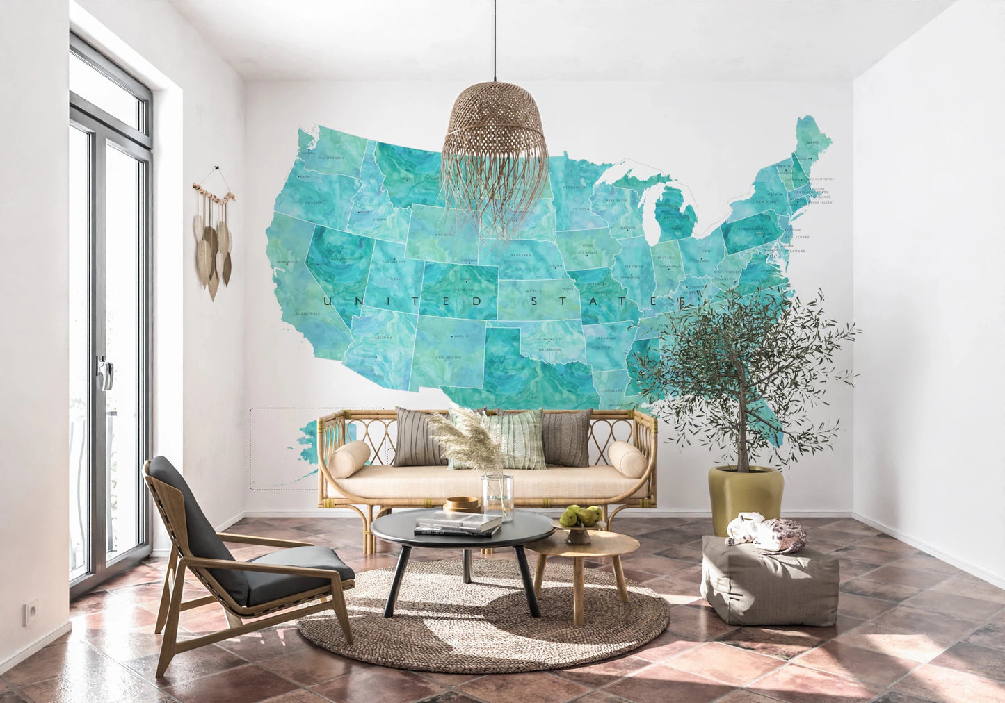 USA map with states and capitals in teal watercolor wallpaper mural behind a cane sofa and olive tree in a living room