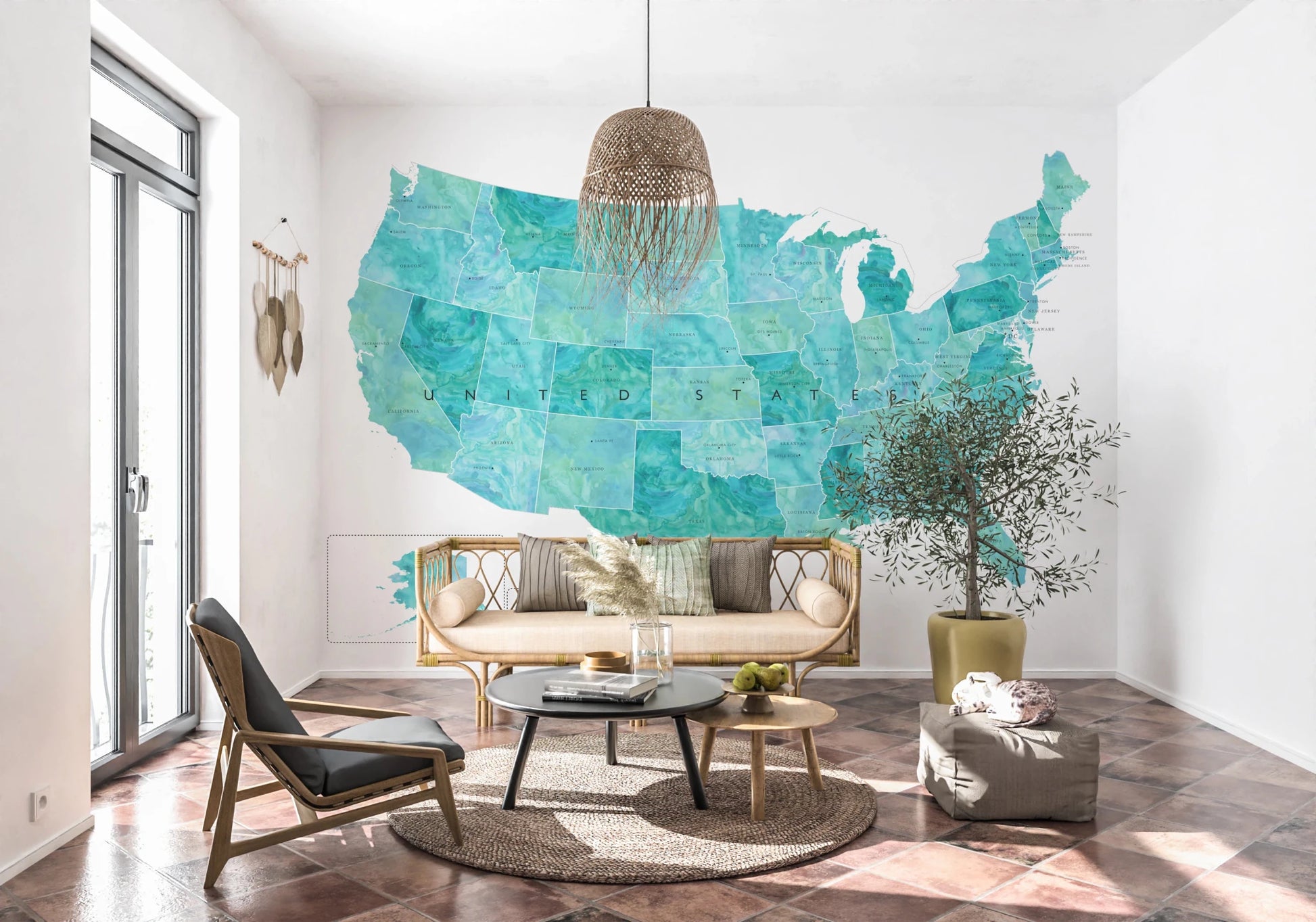 USA map with states and capitals in teal watercolor wallpaper mural behind a cane sofa and olive tree in a living room