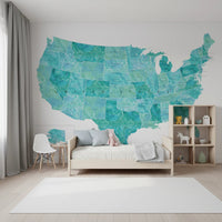 USA map with states and capitals in teal watercolor wallpaper mural in a kids bedroom with a wood bed and toys