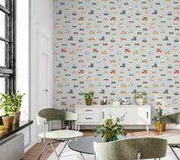 Vehicles in blue background wallpaper behind a white sideboard and green chairs in a loft-window living room