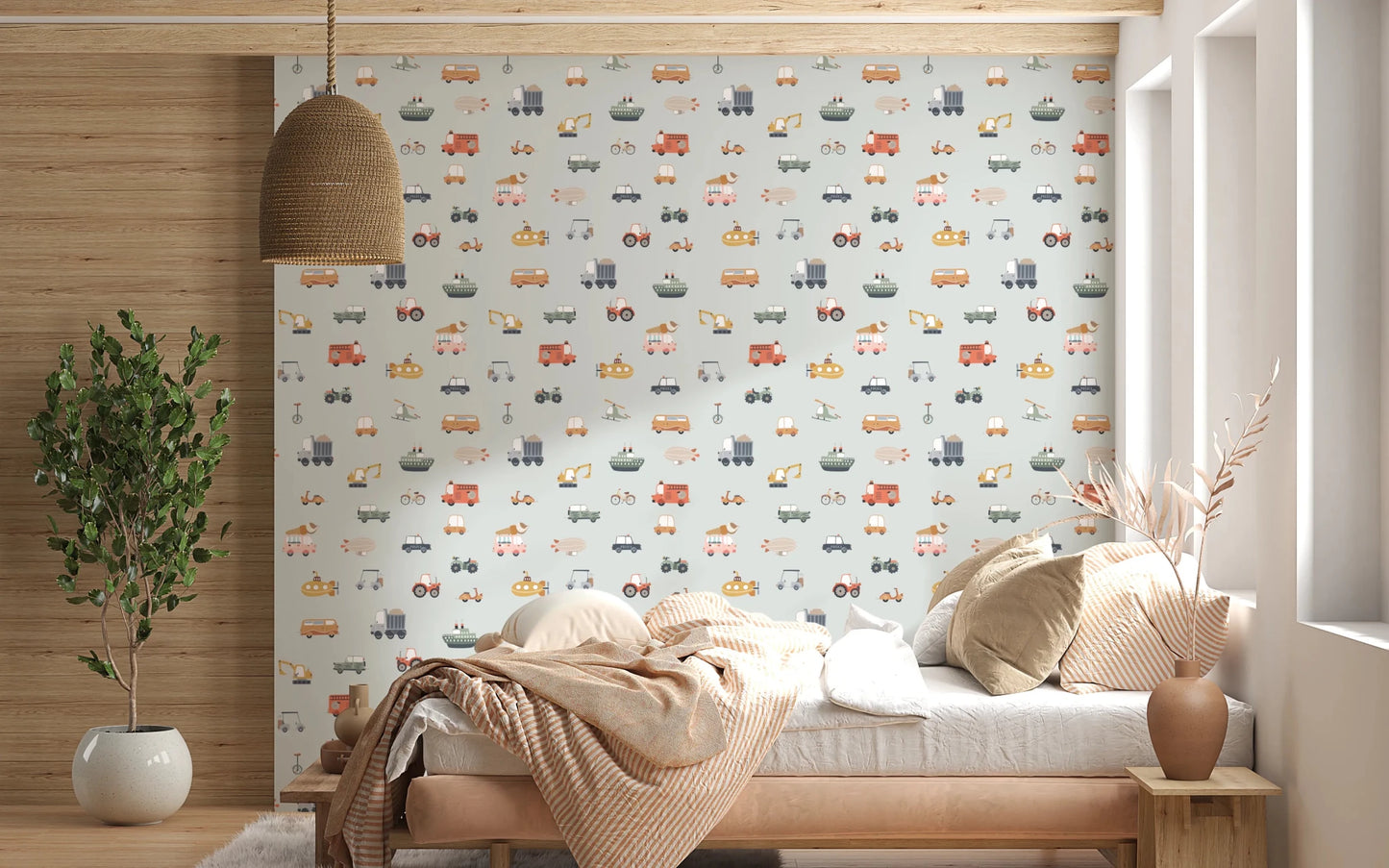 Vehicles in blue background wallpaper behind a wood daybed with striped bedding and rattan pendant lamp