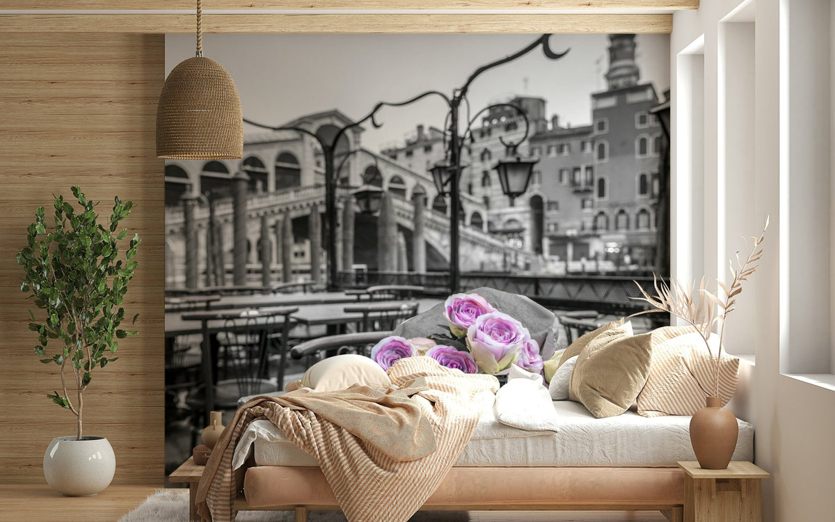 Venetian Blooms wallpaper mural with black-and-white Venice Rialto Bridge and pink roses behind a bedroom bed in peach bedding