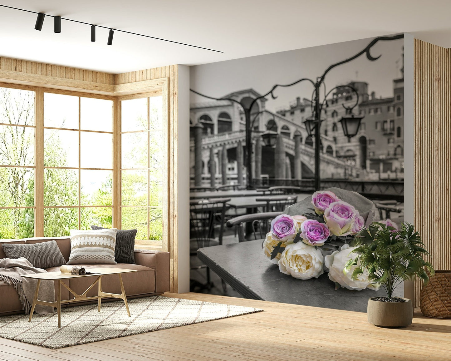 Venetian Blooms wallpaper mural showing pink and white roses over grey Venice canal beside a brown sofa by tall living room windows