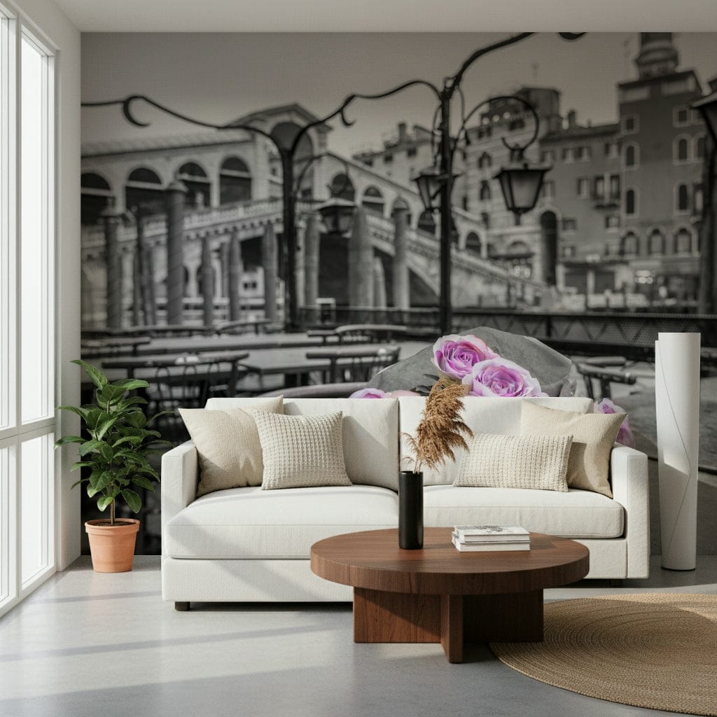 Venetian Blooms wallpaper mural showing pink roses over monochrome Venice behind a cream sofa and round wood coffee table