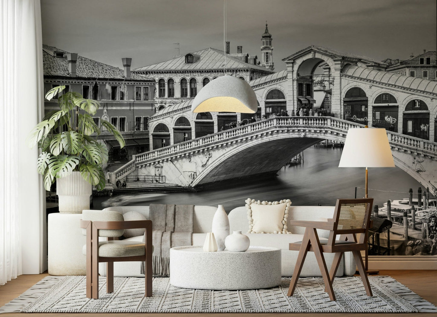 Venetian Bridge Serenity wallpaper mural of the Rialto Bridge behind a white boucle sofa with dome pendant and monstera