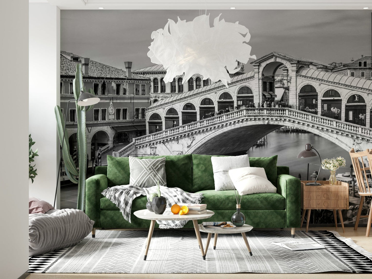 Venetian Bridge Serenity wallpaper mural of the grey Rialto Bridge behind a green velvet sofa with tall cactus