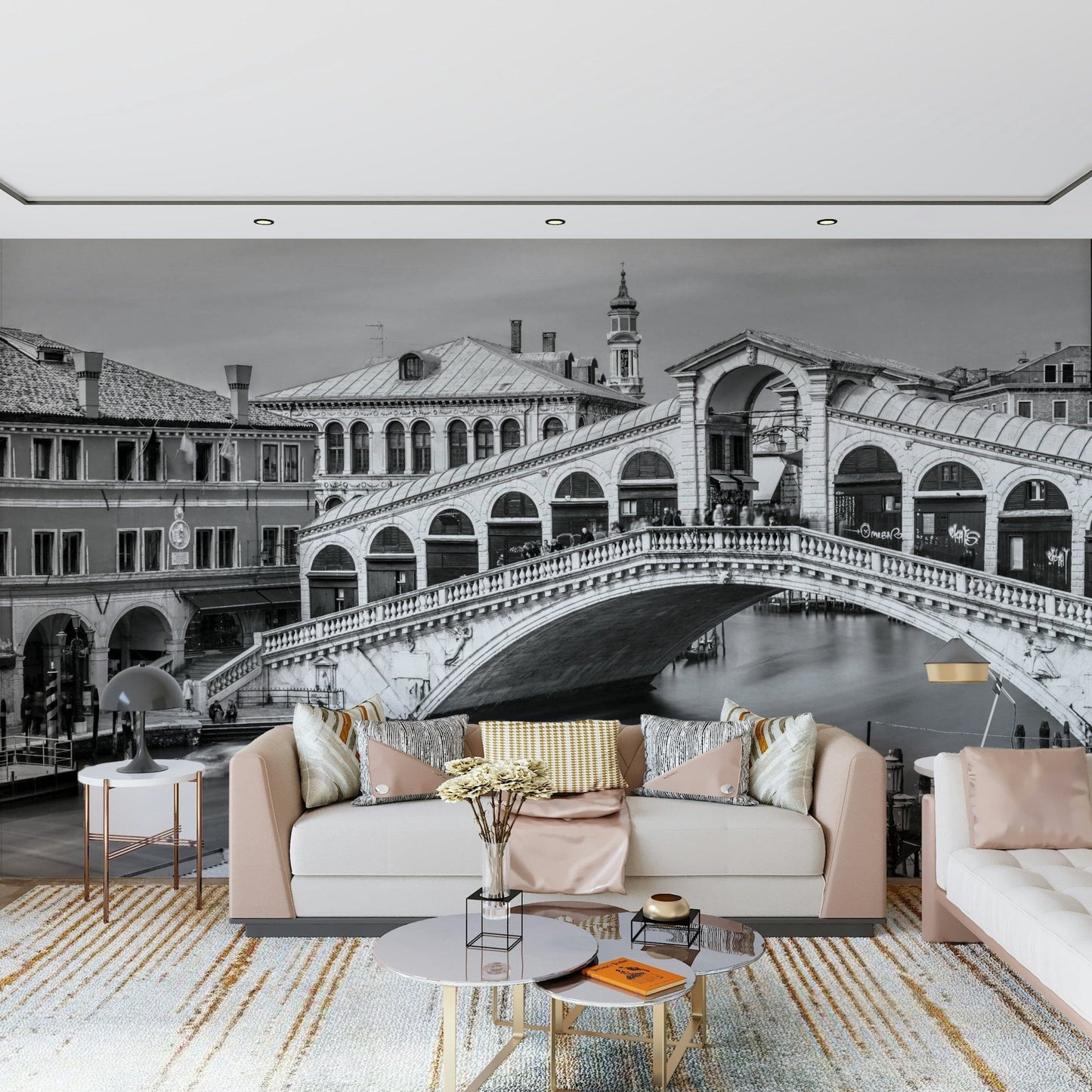 Venetian Bridge Serenity wallpaper mural of the Rialto Bridge behind a blush sofa with gold-accent round tables