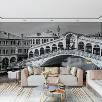 Venetian Bridge Serenity wallpaper mural of the Rialto Bridge behind a blush sofa with gold-accent round tables
