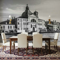 Venice Cityscape wallpaper mural of a black and white domed church across the water above a dining table and ornate rug