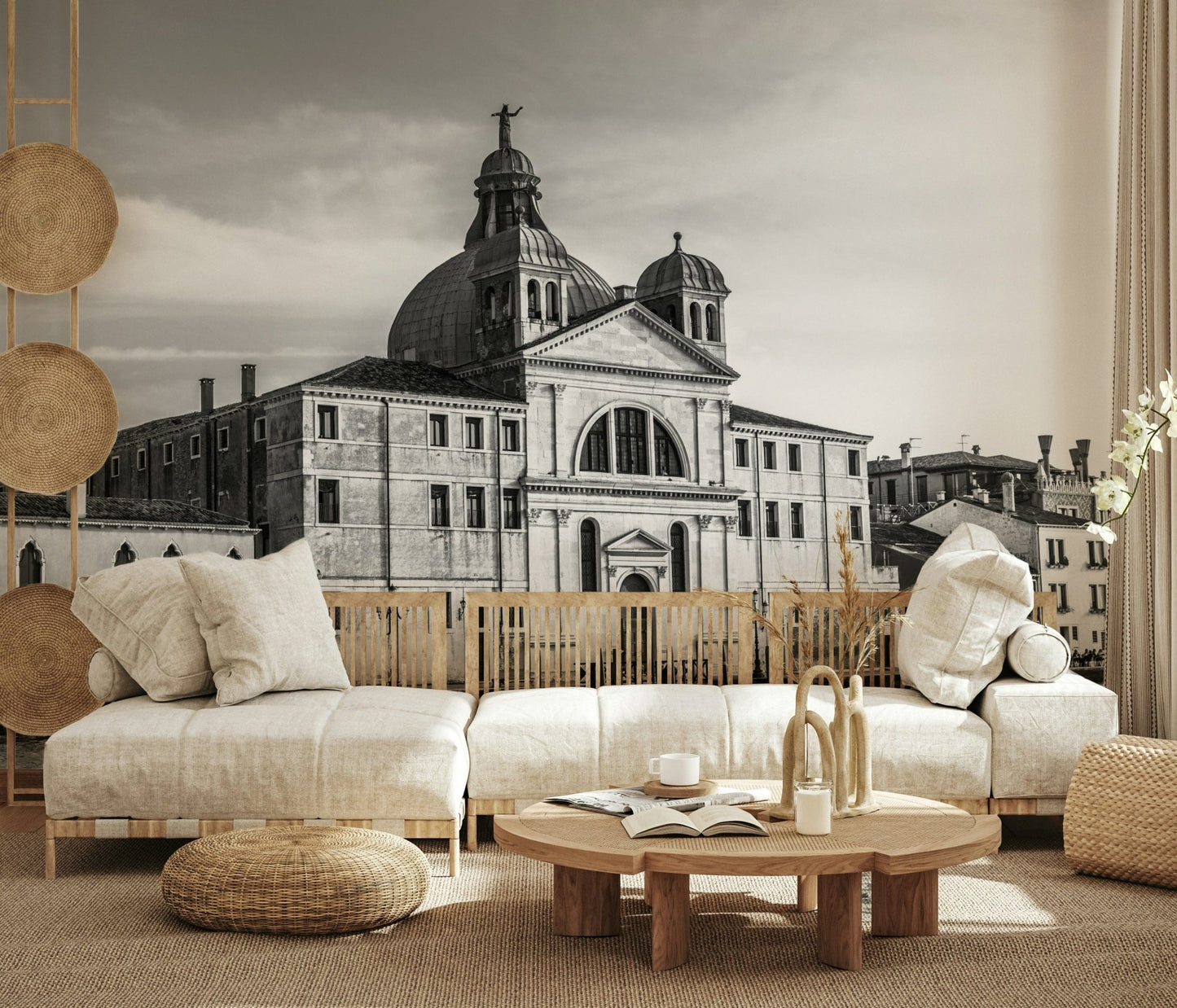 Venice Cityscape wallpaper mural of a grey Venice church behind a cream low sectional with rattan poufs and jute rug
