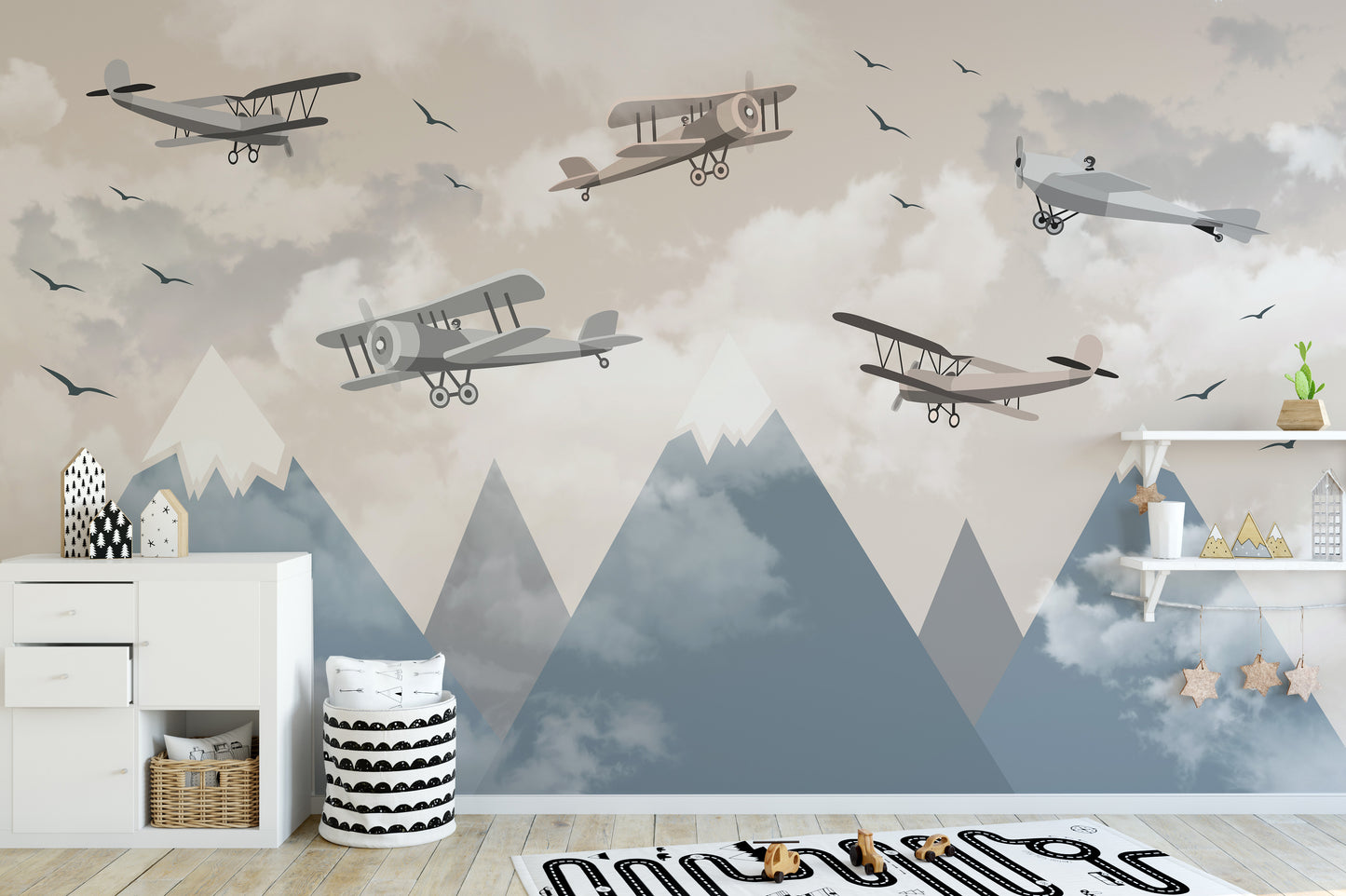 Vintage Aircraft wallpaper mural with biplanes over blue mountains above a white sideboard in a kids room