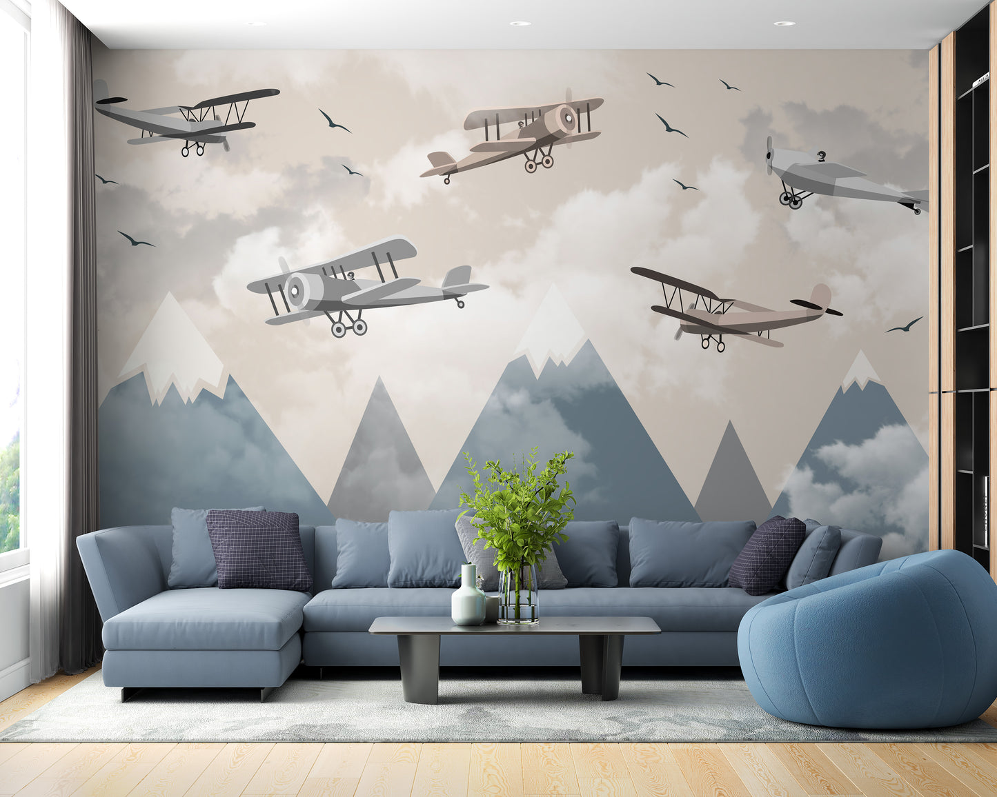 Vintage Aircraft wallpaper mural with biplanes and blue mountains behind a blue sectional sofa
