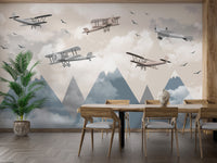 Vintage Aircraft wallpaper mural with biplanes over misty blue peaks behind a wooden dining table