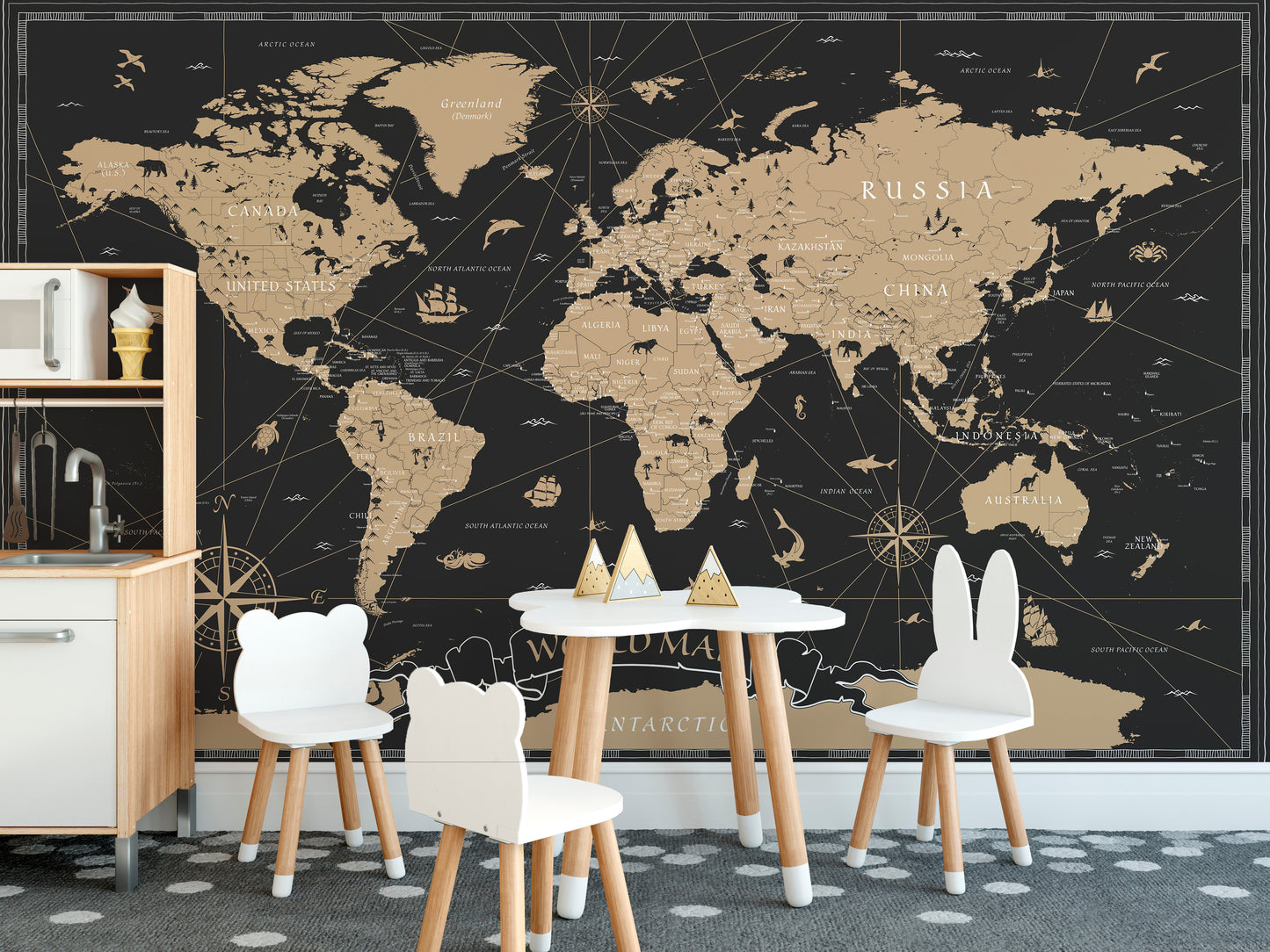 Vintage Black Golden World Map wallpaper mural behind white bear and bunny chairs and a play table in a kids room