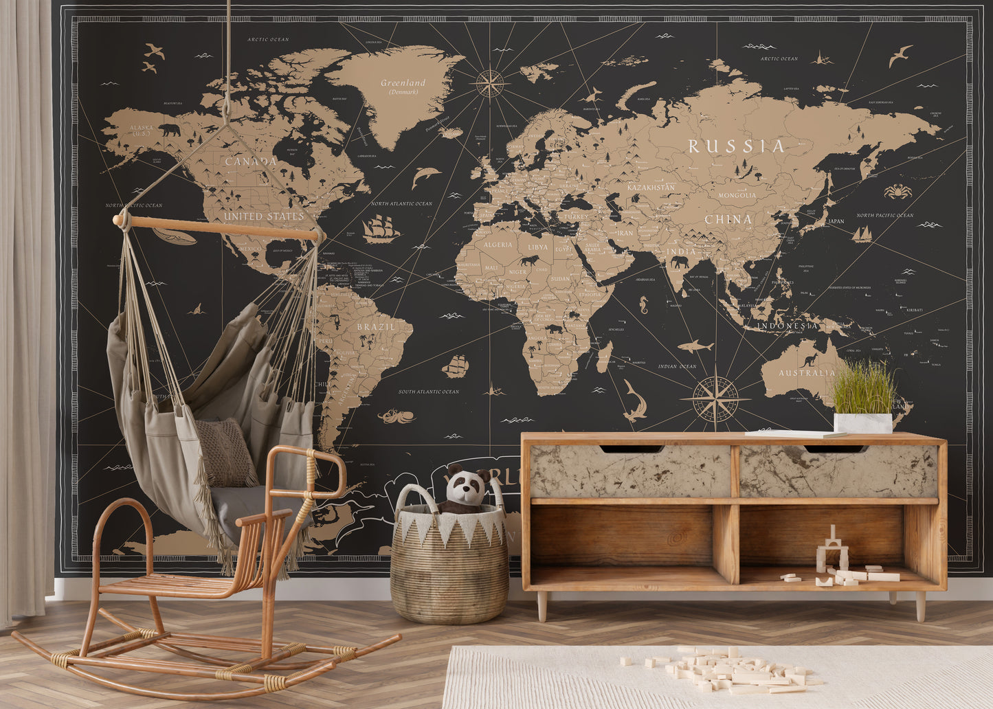 Vintage Black Golden World Map wallpaper mural in black and gold behind a rattan hanging chair and wood console in a kids room