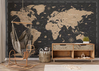 Vintage Black Golden World Map wallpaper mural in black and gold behind a rattan hanging chair and wood console in a kids room