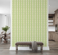 Vintage Bloom Rows wallpaper mural on a divider wall above a brown velvet bench, green daisy stripes