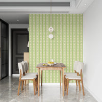Vintage Bloom Rows wallpaper mural in a dining room behind a wood table and beige chairs, green daisy stripes